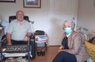 Norman at home with Jean, one of Strathcarron's 112 Compassionate Neighbour volunteers