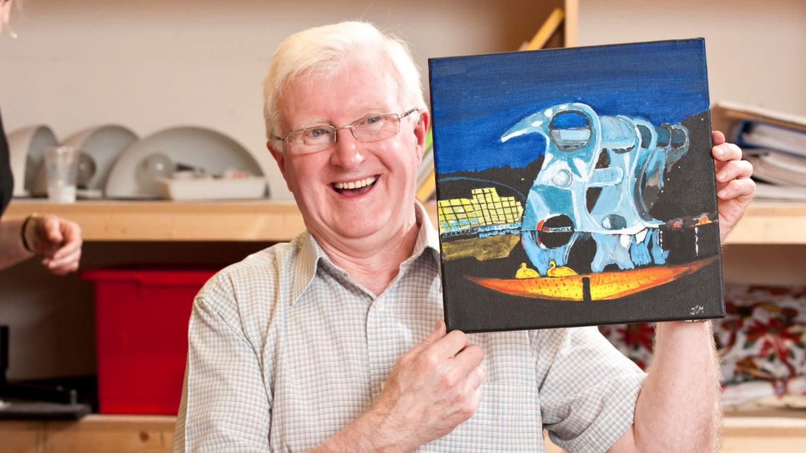 Man holding up a painting of the Falkirk Wheel